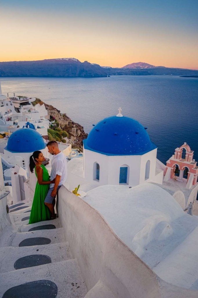 woman wearing a romantic dress for Santorini Greece in the color green